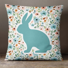 Load image into Gallery viewer, An Easter pillow cover featuring a spring floral pattern in pastel shades of blue, pink, and green with a blue silhouette of a bunny. The design is printed on both sides of the cover. The cover is made from high-quality, durable fabric and features a zipper closure. It measures 18&quot;x18&quot; and fits standard pillow inserts.
