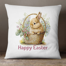 Load image into Gallery viewer, A Easter pillow cover with an Easter Bunny in a basket surrounded by flowers with the words &quot;Happy Easter&quot; printed below it. 
